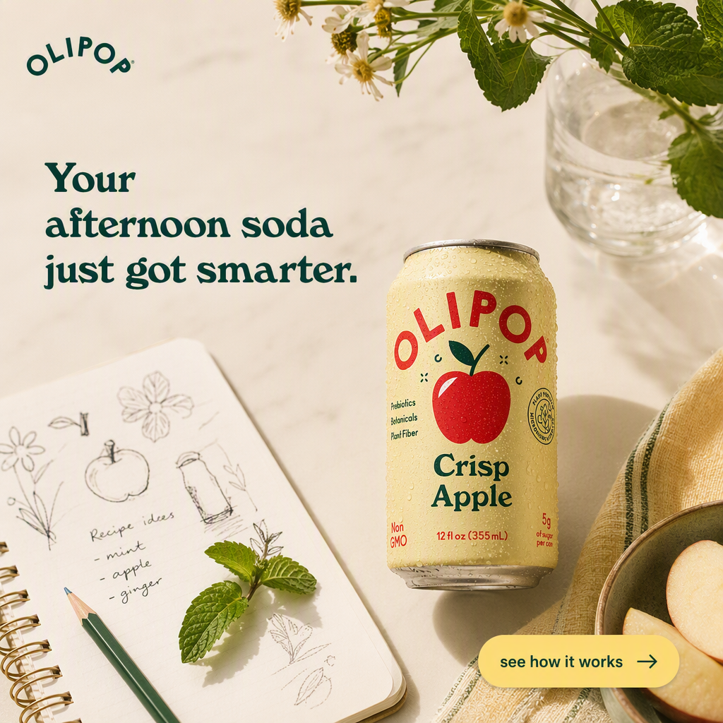 AI-generated OLIPOP ad: a pale yellow Crisp Apple can beaded with condensation beside a spiral sketchbook of recipe ideas, mint sprigs, apple slices and a glass of flowers, headlined "Your afternoon soda just got smarter." with a yellow "see how it works" button
