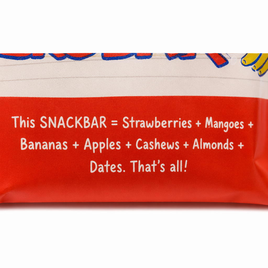 Extreme macro crop of The Whole Truth Mixed Fruit Snackbar wrapper, showing only the red panel with the text "This SNACKBAR = Strawberries + Mangoes + Bananas + Apples + Cashews + Almonds + Dates. That's all!"