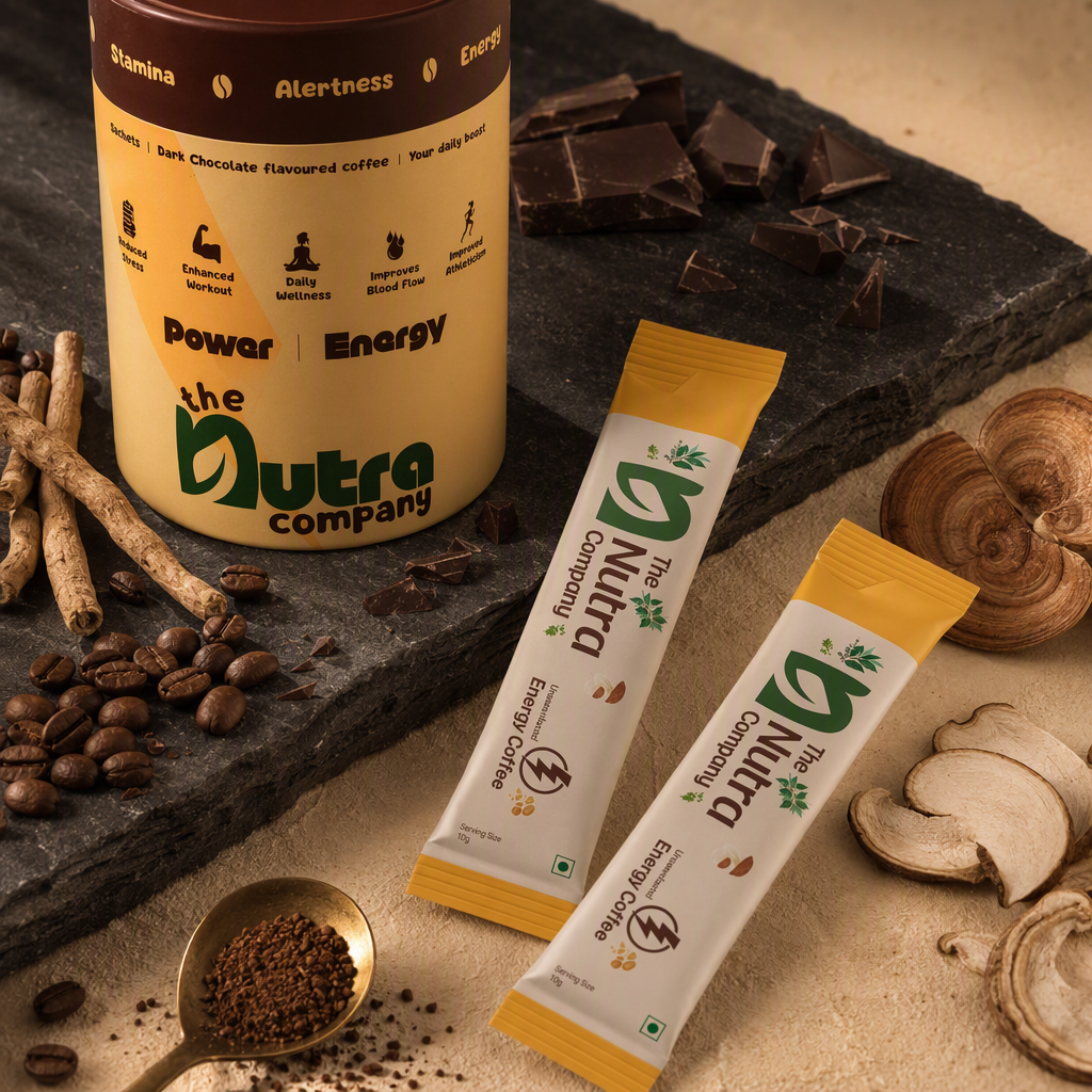 AI product photography for The Nutra Company's Energy Coffee: the yellow Power Energy canister and two Energy Coffee sachets on dark slate with chocolate pieces, coffee beans, a brass spoon of instant coffee, licorice root and dried mushroom slices