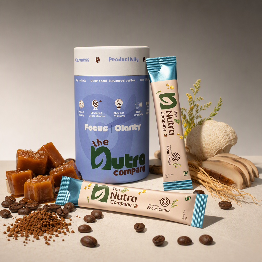 AI product photography for The Nutra Company's Focus Coffee: a lavender Focus Clarity canister and two blue-ended sachets of unsweetened focus coffee on a pale surface, with salted caramel cubes, coffee beans, ground coffee and lion's mane mushroom around them