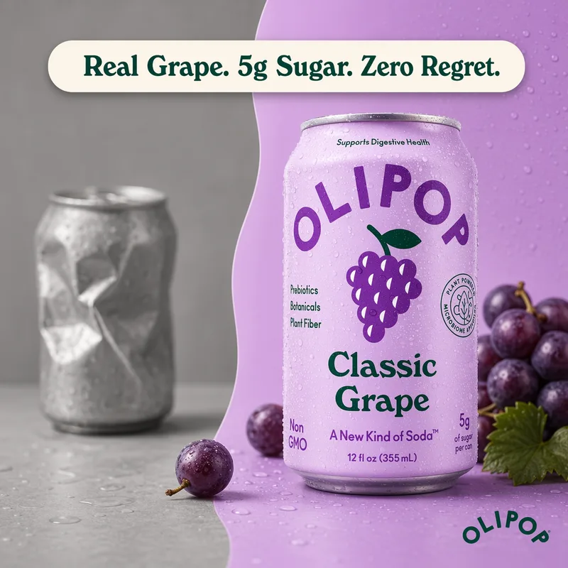 Crushed grey soda can beside a Classic Grape can, real grape and 5g sugar